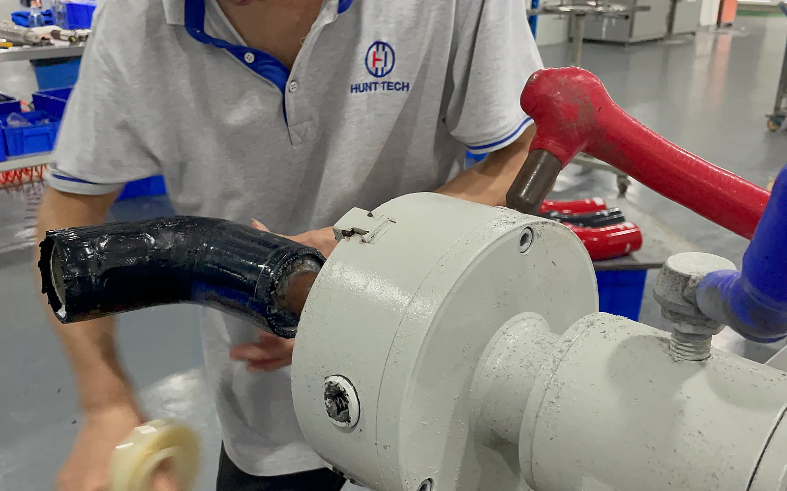 Operator working with a hand-wrapped formed hose on a physical shape reference